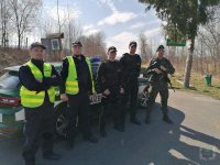 Policjanci, funkcjonariusze straży granicznej i żołnierz pilnują zamkniętego przejścia granicznego w Jarnołtówku