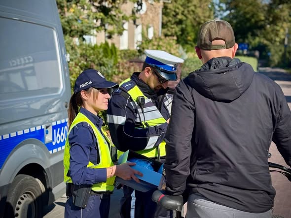 policjanci wręczający kask 