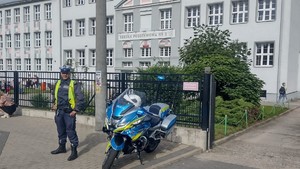 policjant stoi przed szkołą